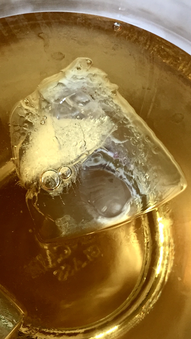 an ice cube floating in Four Roses whiskey